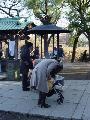 A woman wafting smoke onto her baby